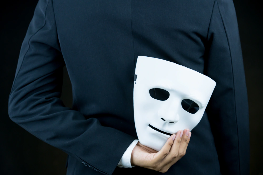 Businessperson holding a white mask